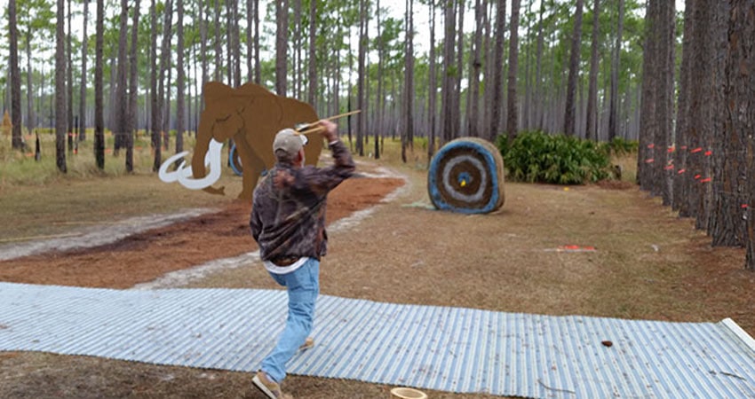 Man throwing arrow at target