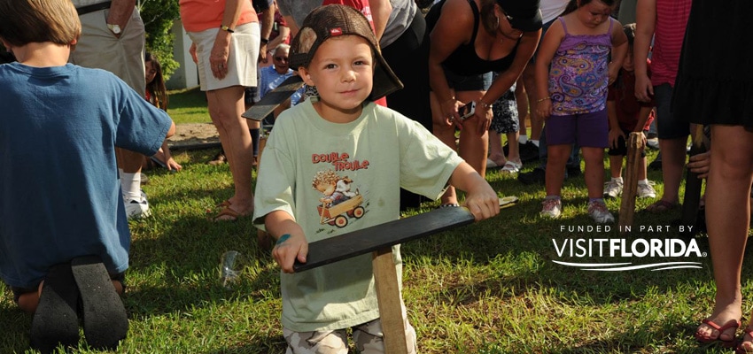 Boy at worm gruntin' festival with visit florida logo